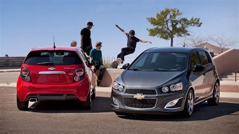 A pair of 2013 Chevy Sonic RS Hatchbacks in Victory Red and Cyber Gray ...