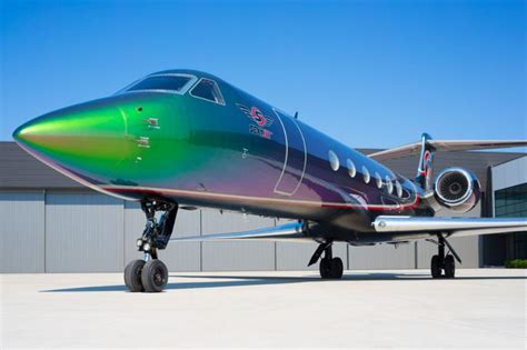 an airplane parked in front of a hangar