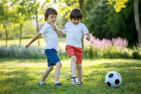 Two cute little kids, playing football together, summertime. Chi Stock Photo by ©t.tomsickova ...