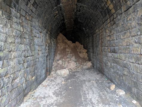 an old tunnel with rocks and dirt on both sides