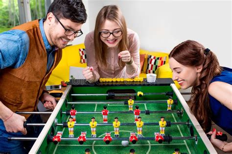 Friends Playing Table Football Stock Photo - Image of male, chummery ...