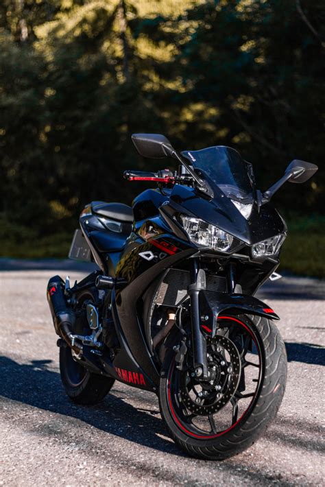 Supersport black and red YAMAHA R3 with Akrapovič exhaust system on forest road Yamaha R3 ...