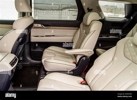 Second row captain’s chairs of the modern SUV car inside. Leather back passenger seats in modern ...