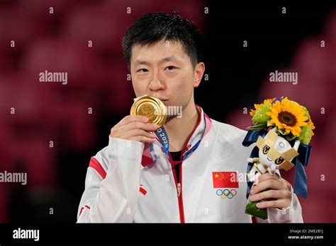 Ma Long of China celebrates with his gold medal for the table tennis ...