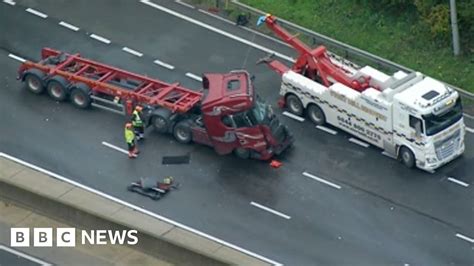 Just Stop Oil protests: Police officer hurt in M25 rolling roadblock crash - BBC News