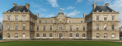 a large building with many windows on the top floor and two towers at the top