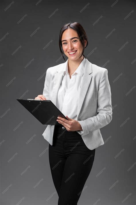 Free Photo | Portrait female lawyer in formal suit with clipboard