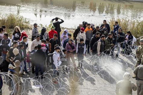 With rifles and razor wire, National Guard and state troopers are blocking migrants at the ...