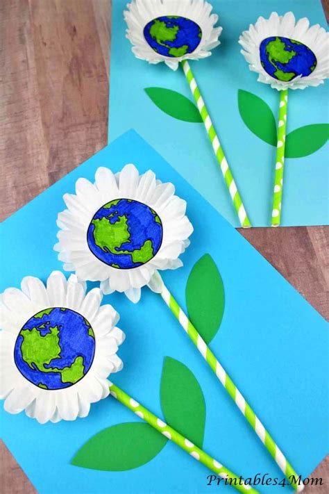 paper flowers made to look like the earth and two straws with green ...