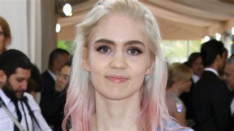 Elon Musk's 'baby mama': Grimes debuts 'scary' chest tattoo | Flipboard