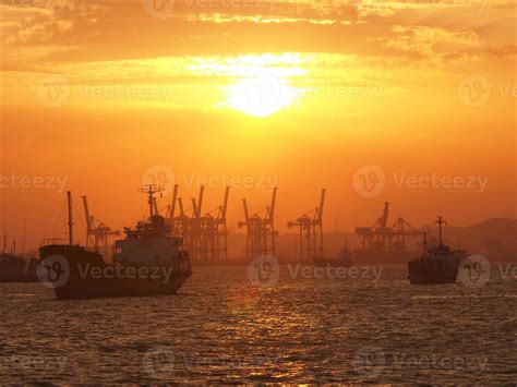 Cargo ship and cranes at port harbour in Tanjung Perak Surabaya with ...