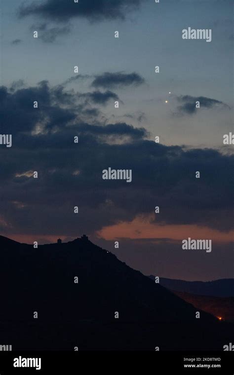 Planets Jupiter and Venus in conjunction rise before sunrise behind Rocca Calascio castle, Italy ...