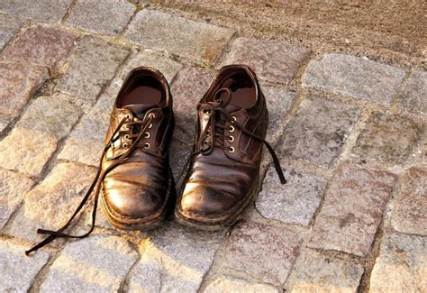 Premium Photo | Old shoes on the cobbled pavement