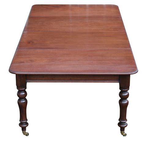 An antique Victorian mahogany extending dining table