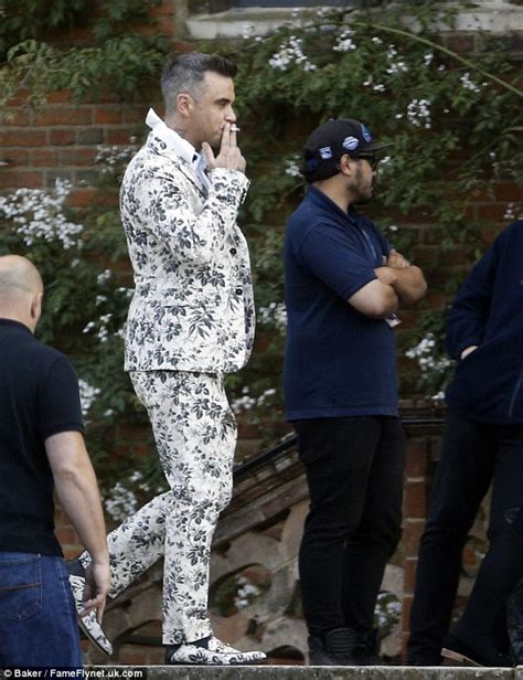 Robbie Williams sports outlandish floral suit and matching loafers as he films for comeback ...