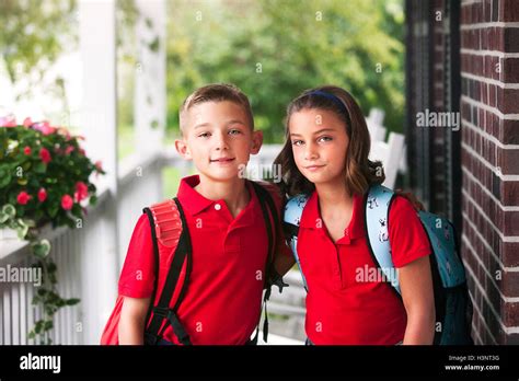 Portrait of twin brother and sister on first day of new school year ...