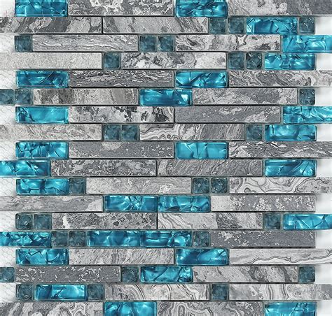 blue and gray glass tile backsplash with silver foil on the bottom, in an irregular pattern