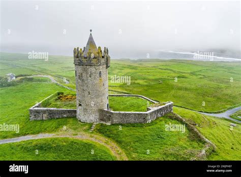 Aerial view of Doonagore Castle, round 16th-century tower house with a ...