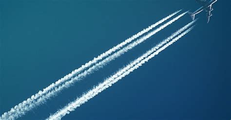 White Airplane with Smoke under Blue Sky · Free Stock Photo