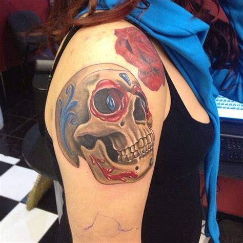 a woman with a skull tattoo on her shoulder