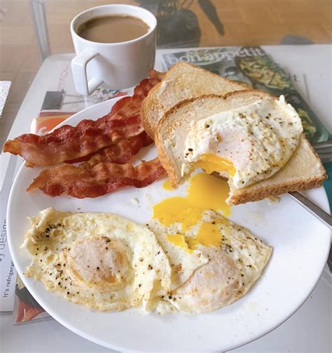 Starting the day with a proper breakfast. Three eggs over easy, bacon & toast. : FoodPorn