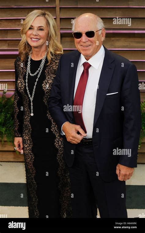 Recording artist Jimmy Buffet (R) and wife Jane Slagsvol attend the 2014 Vanity Fair Oscar Party ...