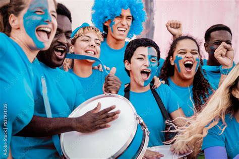 Multiracial football fans celebrating in crowd while watching game at sport stadium - Soccer ...