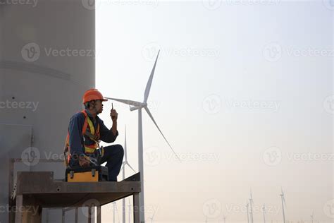 Specialist wind turbine technician working at the base of the turbine. Wind turbine service ...