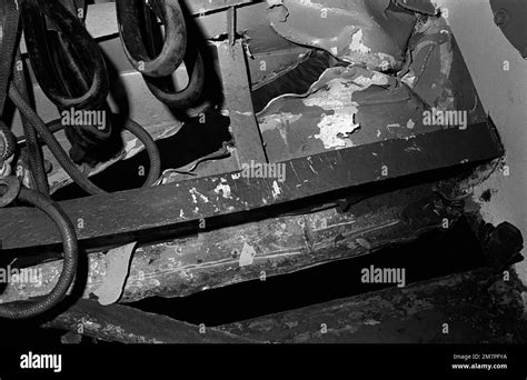 A view of damage caused to the port side of the aircraft carrier USS ...