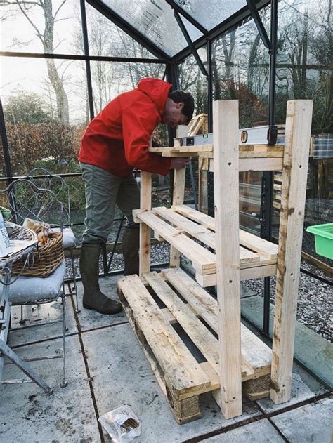 Making greenhouse staging from pallets | Outdoor greenhouse, Greenhouse staging, Backyard greenhouse