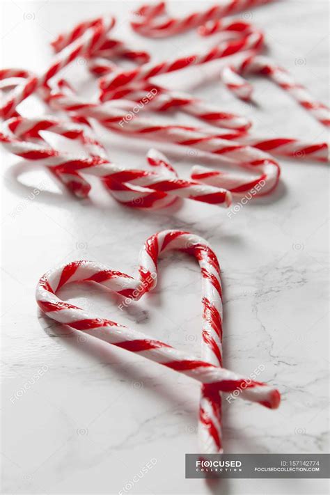 Candy canes forming a heart shape — close up, marble - Stock Photo ...