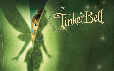 the tinker bell fairy is peeking out from behind a leaf