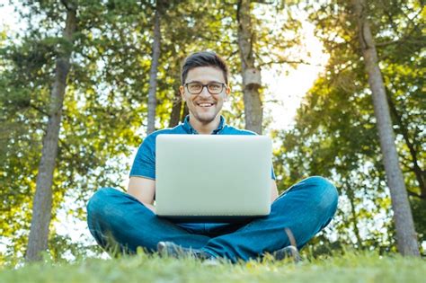 Premium Photo | Man with laptop sitting outdoors in nature