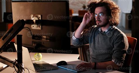 man working on computer in dark office 11310154 Stock Photo at Vecteezy