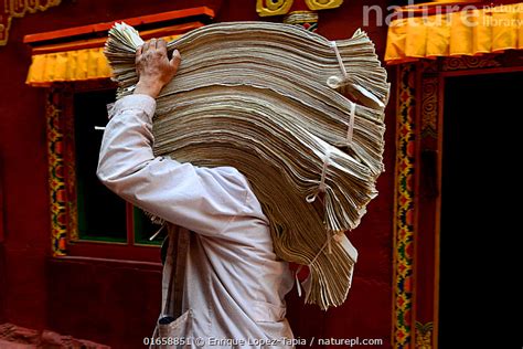 Stock photo of Person carrying printed material at Gonchen Gompa / Derge Monastery, home ...