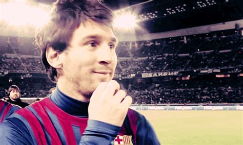 a man standing in front of a crowd at a soccer game with his hand on his face