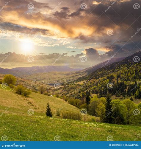 Village On Hillside Meadow With Forest In Mountain At Sunrise Stock ...