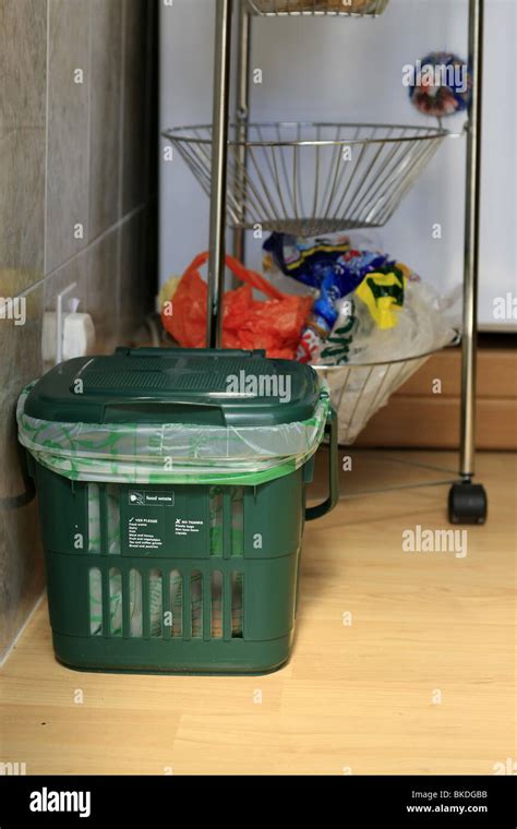 A Green food waste recycling dustbin for use in the kitchen of homes in England Stock Photo - Alamy