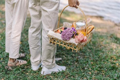 Premium Photo | Couple walking in garden with picnic basket in love ...