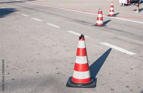 Traffic cones with white and red stripes on the road of the airport. Safety cone Stock Photo ...