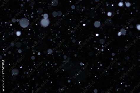 Real falling snow on a black background for use as a texture layer in your project. Add as ...