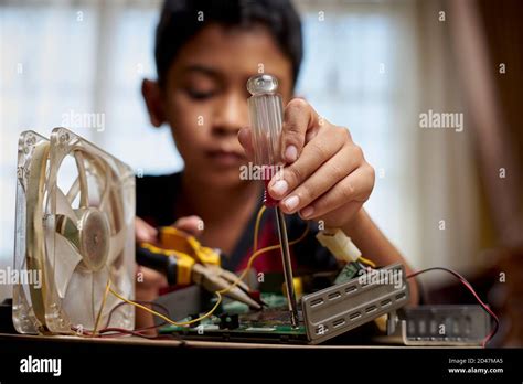 Asian Schoolboy studying electronic at home Stock Photo - Alamy