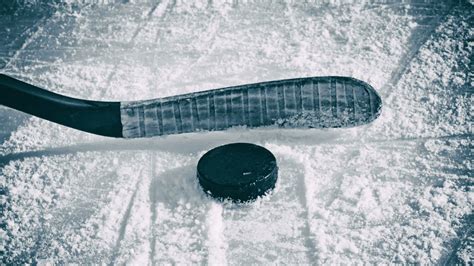 Hockey stick and puck on the ice - backiee