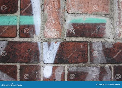 Brick wall with graffiti stock photo. Image of cracked - 86106154