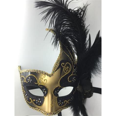 Black and gold feathered Mardi Gras mask with ribbon ties. Each of ...