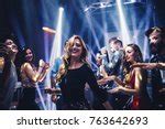 Free Image of Group of dancing cheering people at a nightclub | Freebie.Photography