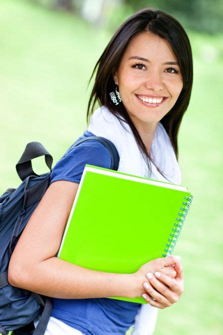 Happy female student with backpack and notebooks smiling | Freestock photos