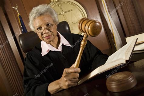 Judge Holding Gavel In Courtroom — Stock Photo © londondeposit #21862077