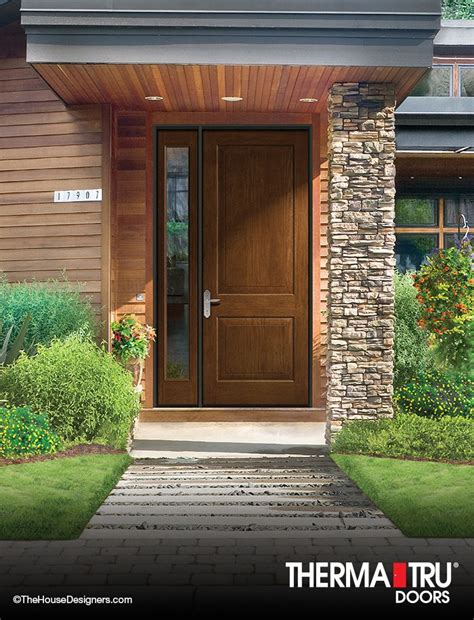 the front entrance to a house with two brown doors and brick steps leading up to it