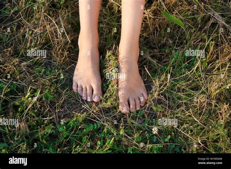 Bare feet of a teenage girl on a summer grass Stock Photo - Alamy